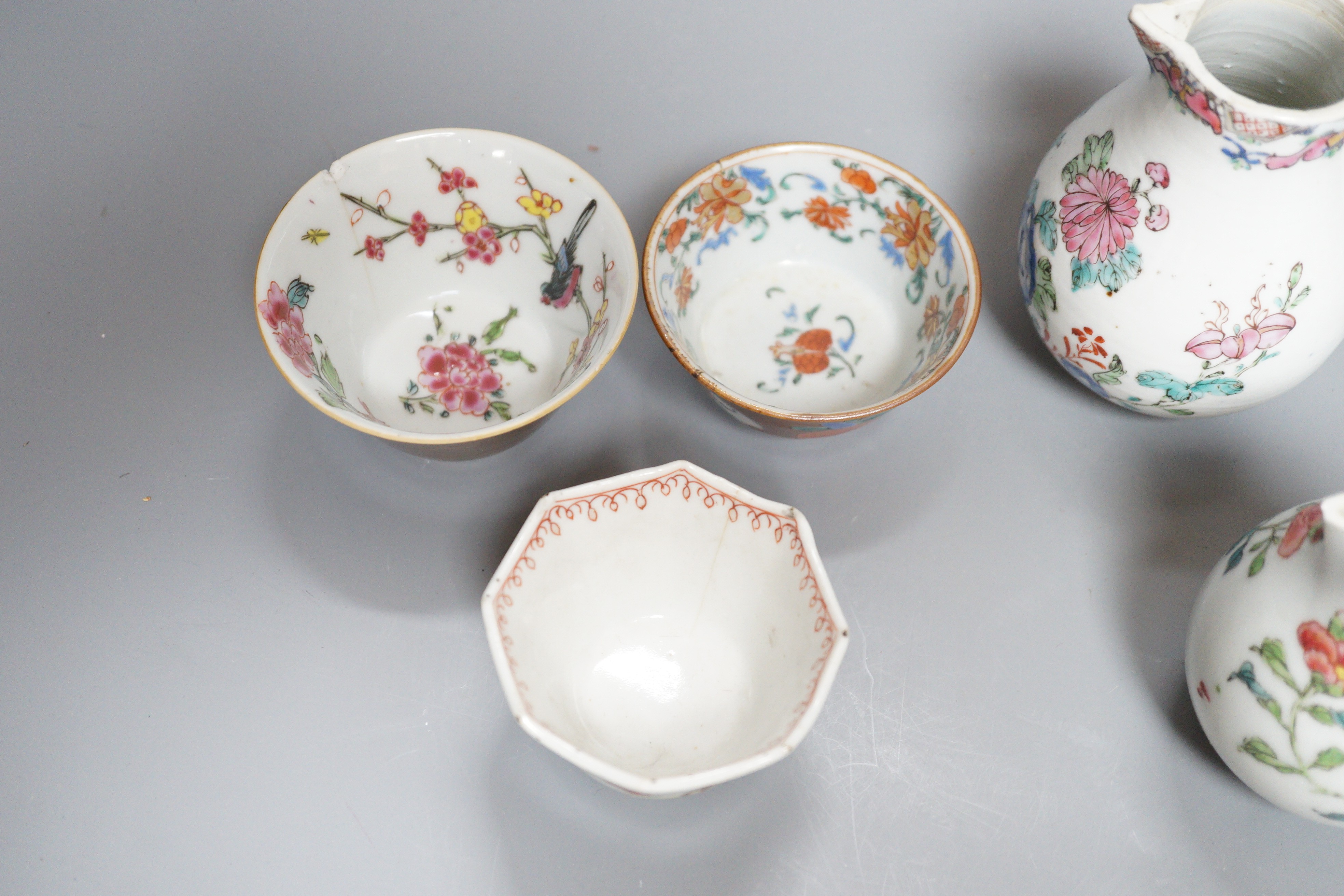 Three Chinese export famille rose cream jugs, one with pierced cover and three small bowls, 18th century and later